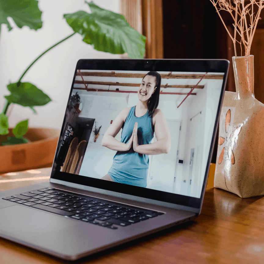 Woman doing yoga pose on computer screen